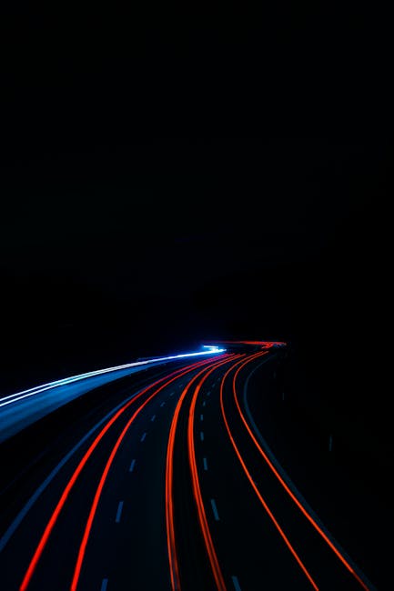 Long exposure of light trails on a highway at night, creating a mesmerizing visual in Ilsfeld, Germany.